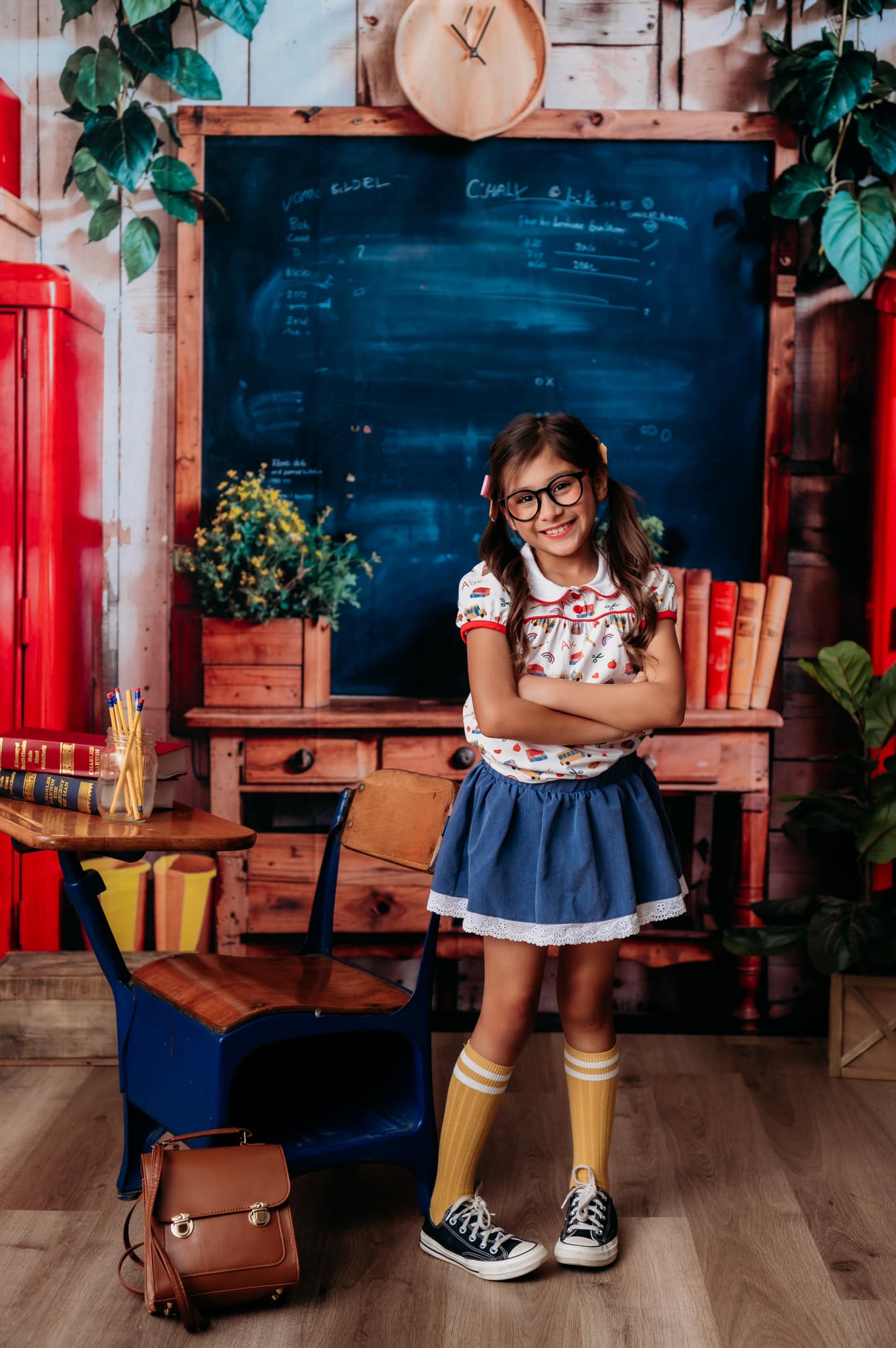 A girl standing in front of the blackboard back to school backdrop